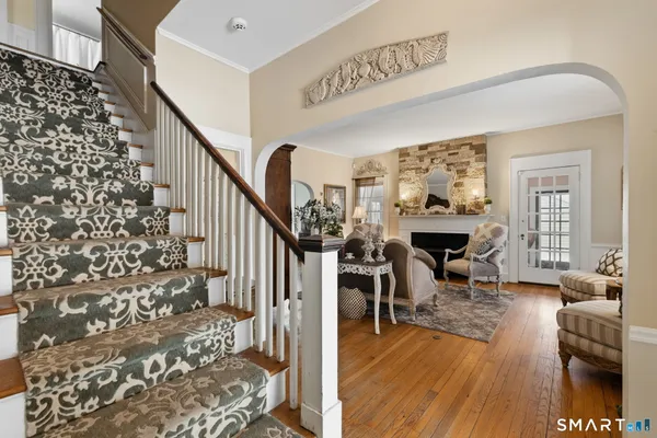 a view of entryway livingroom and hall with wooden floor
