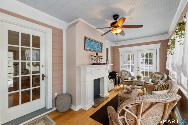 a living room with furniture a fireplace and a flat screen tv