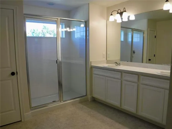 a bathroom with a double vanity sink and a mirror