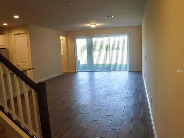 a view of wooden floor and windows in a room