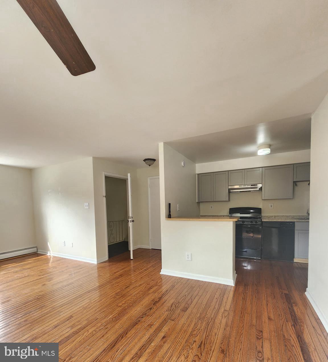 157 Meadowbrook Lane, Unit 2 Brookhaven, PA 19015 - Photo 1 of 17 a view of a kitchen with wooden floor and a sink