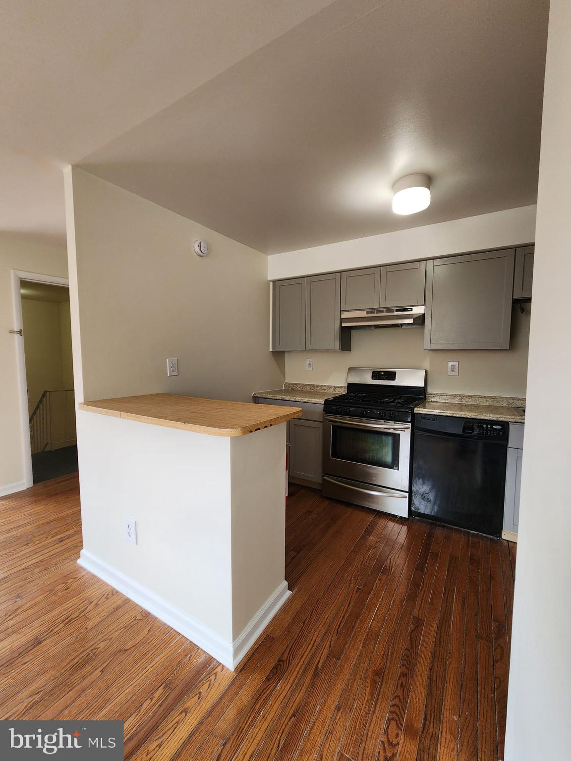 157 Meadowbrook Lane, Unit 2 Brookhaven, PA 19015 - Photo 14 of 17 a kitchen with stainless steel appliances a stove and cabinets