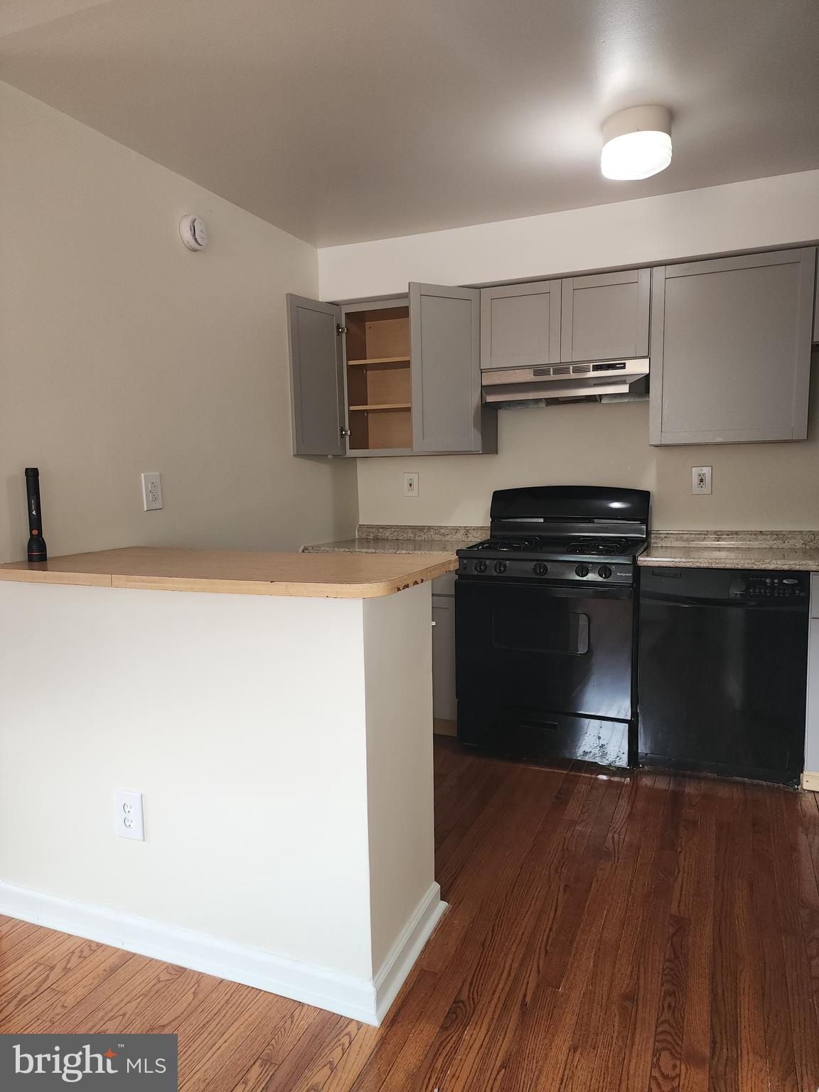 157 Meadowbrook Lane, Unit 2 Brookhaven, PA 19015 - Photo 16 of 17 a kitchen with a stove and a refrigerator
