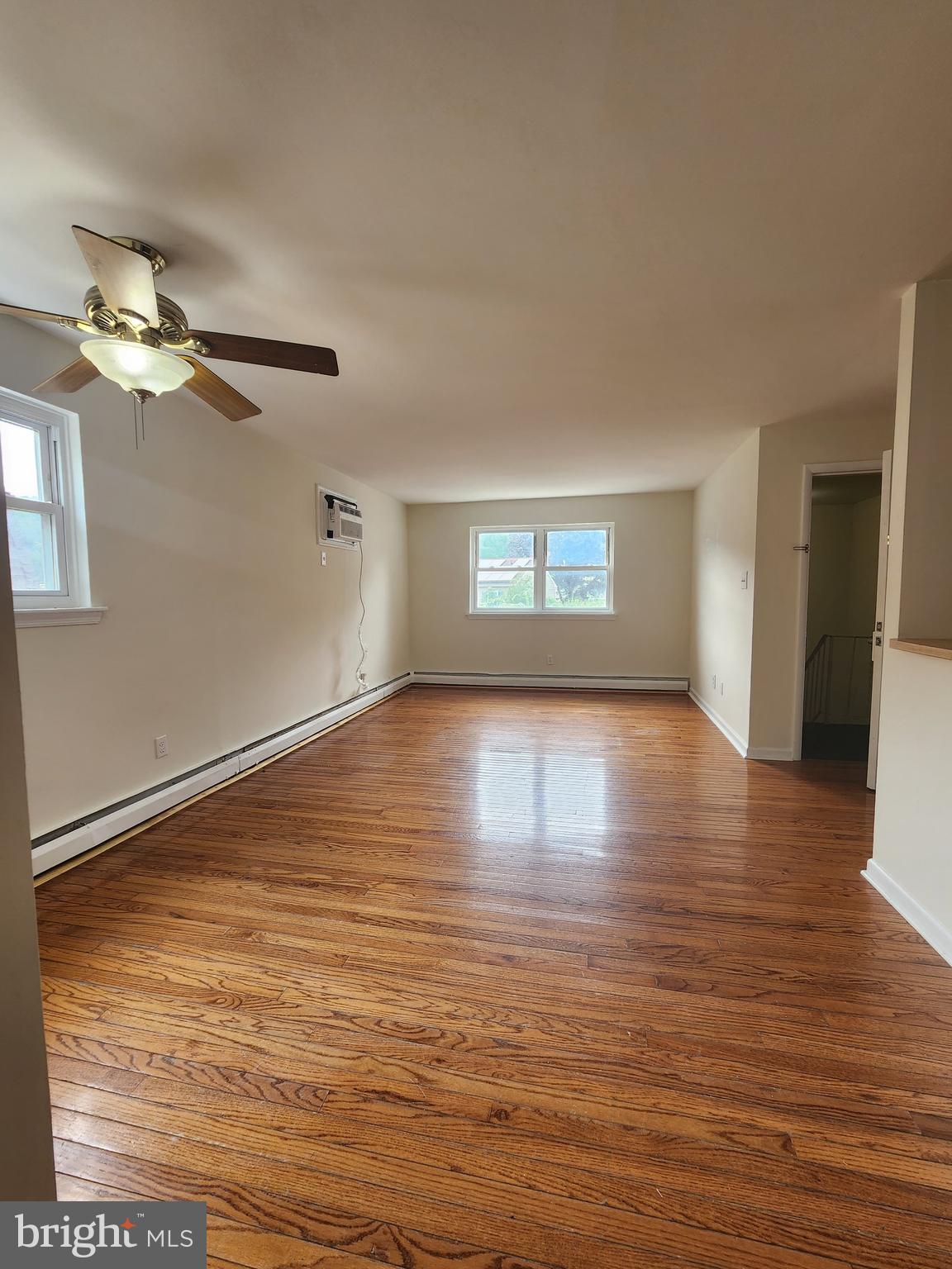 157 Meadowbrook Lane, Unit 2 Brookhaven, PA 19015 - Photo 17 of 17 a view of empty room with wooden floor and fan