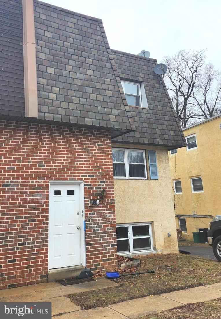 157 Meadowbrook Lane, Unit 2 Brookhaven, PA 19015 - Photo 4 of 17 a front view of a house with a brick wall