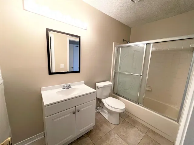 a bathroom with a toilet sink and a mirror