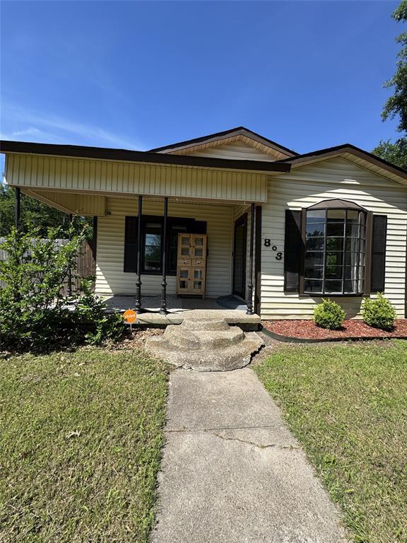 803 Ripley Avenue Ennis, TX 75119 - Photo 2 of 40 Single-story residence featuring light-colored siding and a dark roof