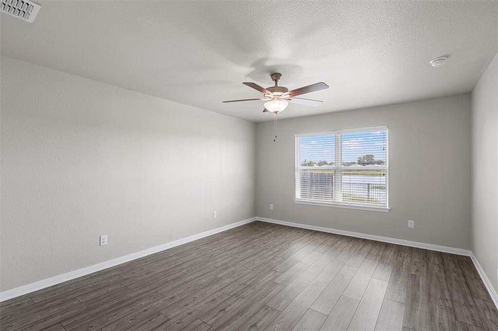 3921 Centerfire Road Waco, TX 76705 - Photo 12 of 16 an empty room with wooden floor and windows