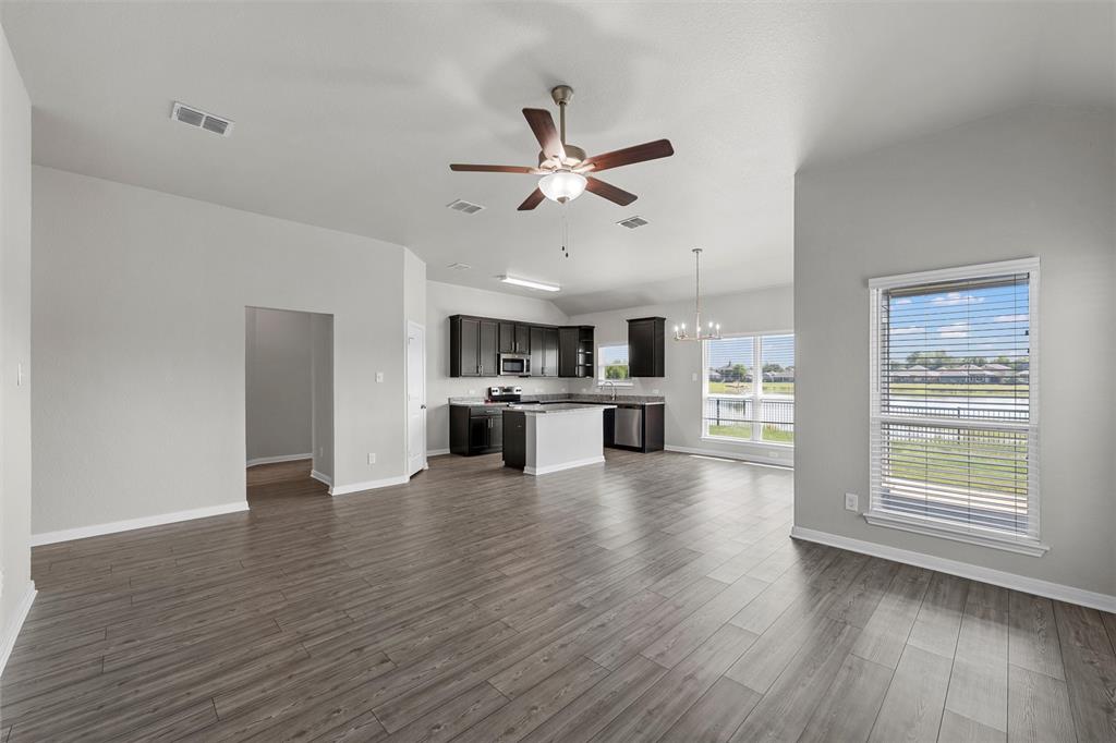 3921 Centerfire Road Waco, TX 76705 - Photo 6 of 16 a view of an empty room with kitchen and window