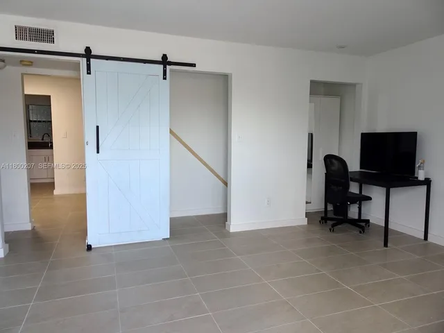 a view of a balcony with wooden bench