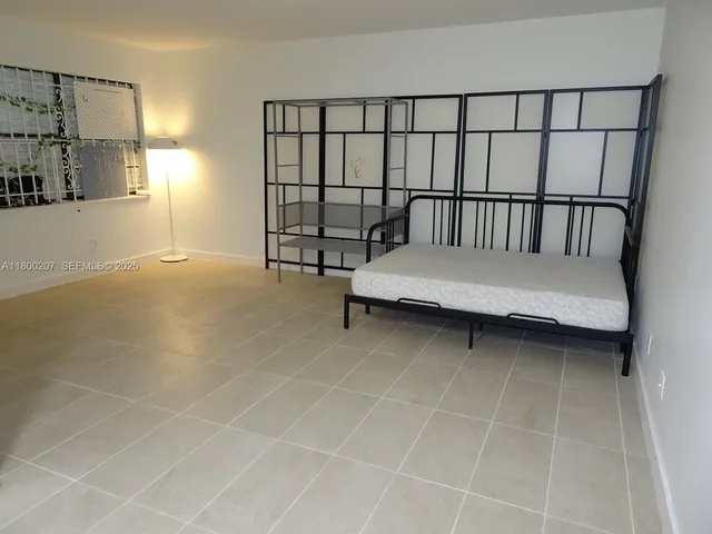 a yellow house with palm tree in front of it