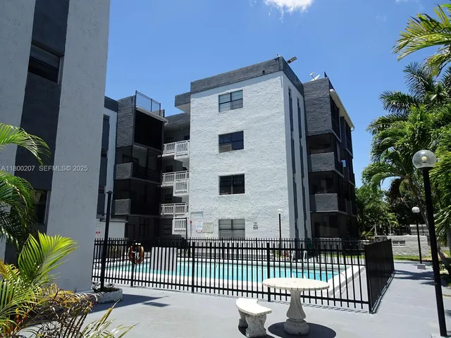 a swimming pool with some potted plants by side of it
