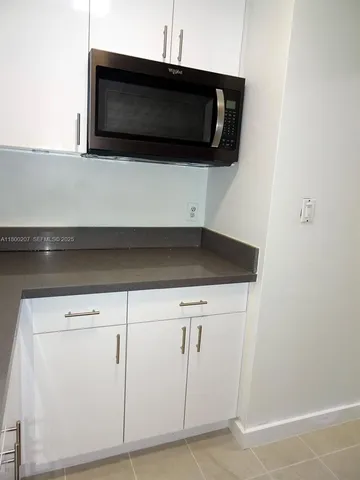 a view of a livingroom with furniture and a flat screen tv