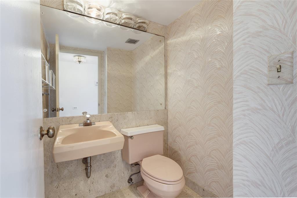 2500 East Las Olas Boulevard, Unit 406 Fort Lauderdale, FL 33301 - Photo 12 of 29 a bathroom with a sink toilet and mirror