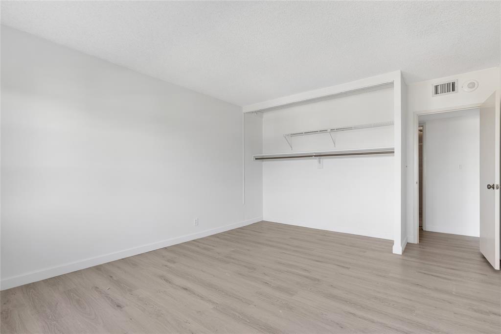 2500 East Las Olas Boulevard, Unit 406 Fort Lauderdale, FL 33301 - Photo 14 of 29 an empty room with wooden floor and closet