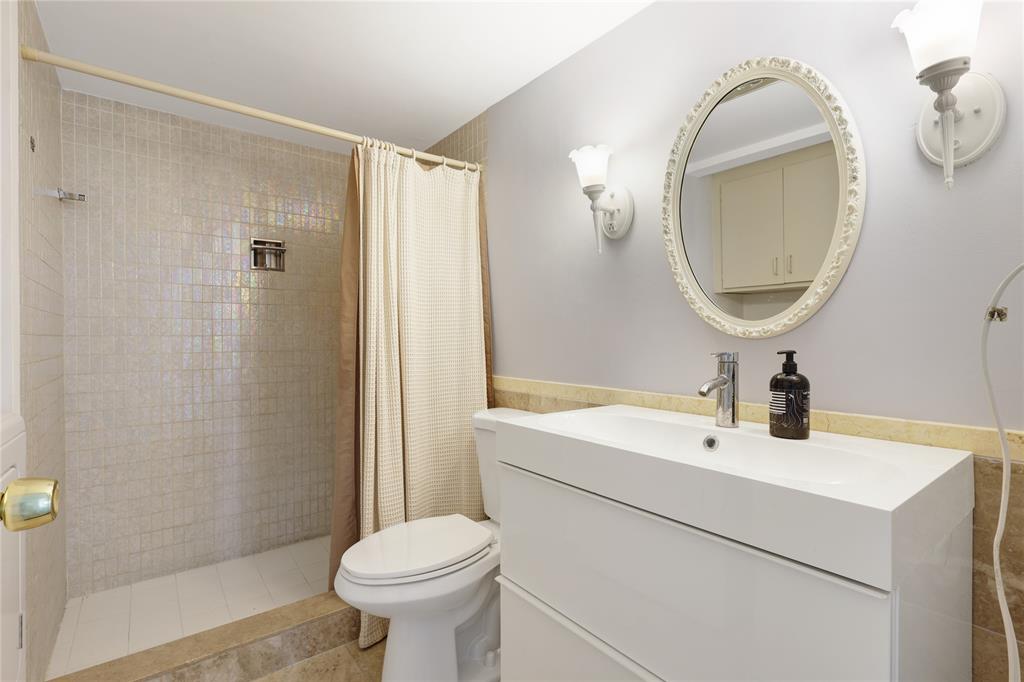 2500 East Las Olas Boulevard, Unit 406 Fort Lauderdale, FL 33301 - Photo 15 of 29 a bathroom with a sink toilet and a mirror