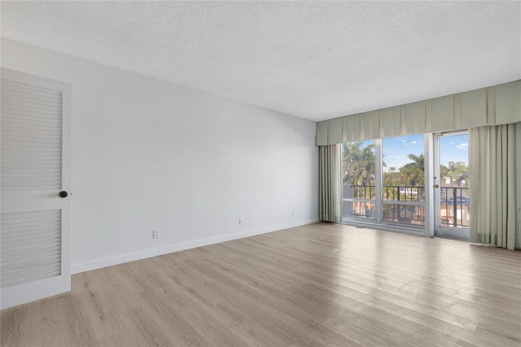 2500 East Las Olas Boulevard, Unit 406 Fort Lauderdale, FL 33301 - Photo 17 of 29 a view of an empty room with wooden floor and a window