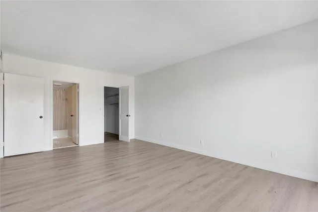 a view of a room with wooden floor