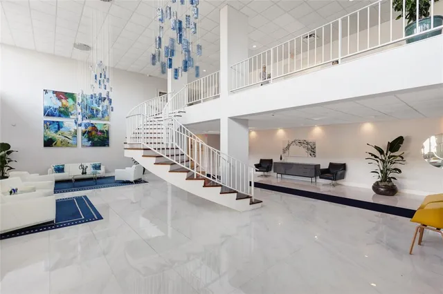 a living room with furniture and large windows