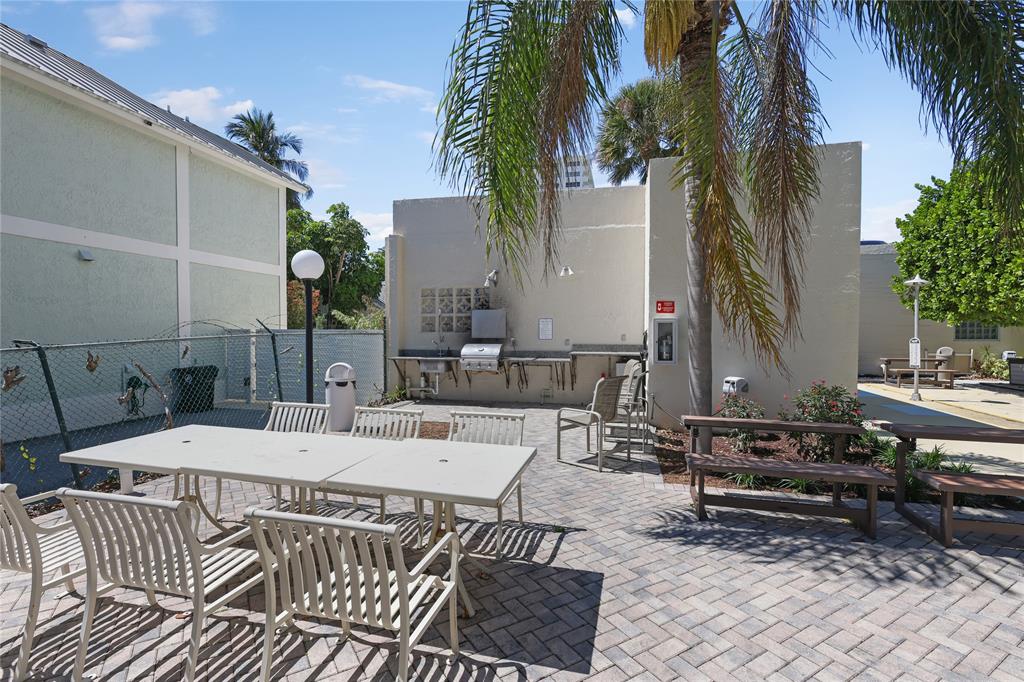 2500 East Las Olas Boulevard, Unit 406 Fort Lauderdale, FL 33301 - Photo 29 of 29 a view of a patio with a table and chairs and potted plants