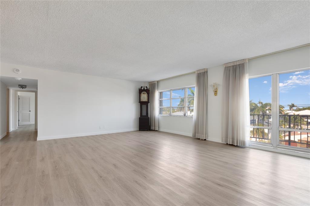 2500 East Las Olas Boulevard, Unit 406 Fort Lauderdale, FL 33301 - Photo 3 of 29 a view of a big room with wooden floor and windows