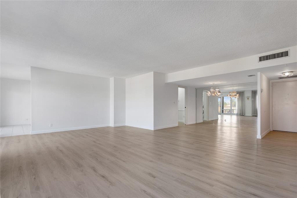2500 East Las Olas Boulevard, Unit 406 Fort Lauderdale, FL 33301 - Photo 6 of 29 a view of an empty room with wooden floor and a window