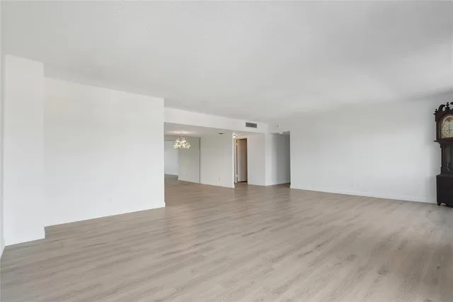 a view of an empty room and wooden floor