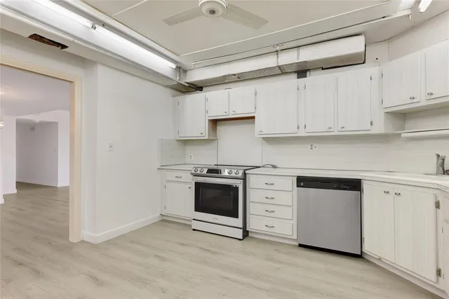 a kitchen with stainless steel appliances granite countertop a stove and a refrigerator