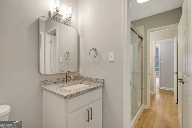 a bathroom with a granite countertop sink and a mirror