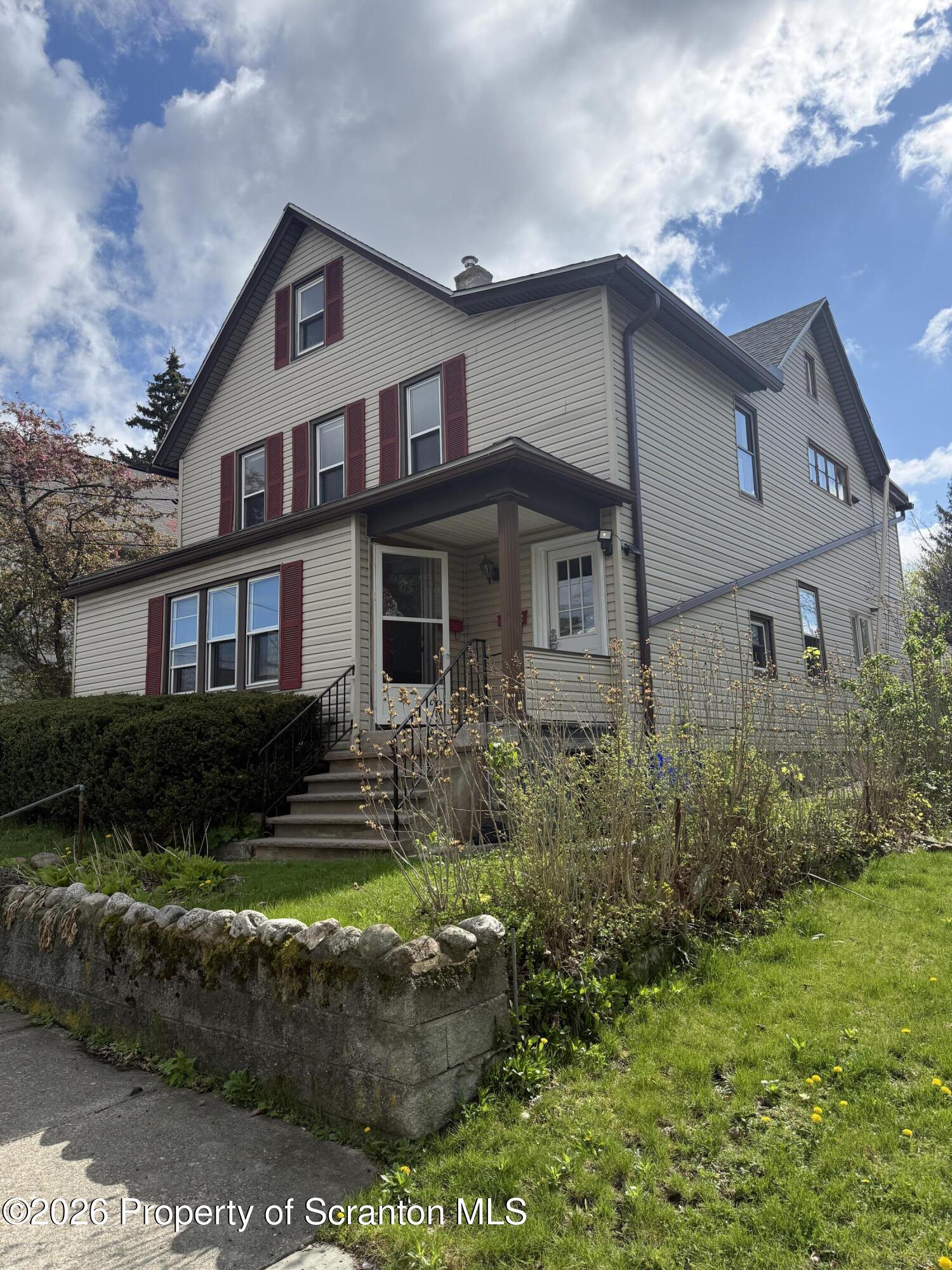1042 Taylor Avenue, Unit 2 Scranton, PA 18510 - Photo 1 of 14 a front view of a house with a yard