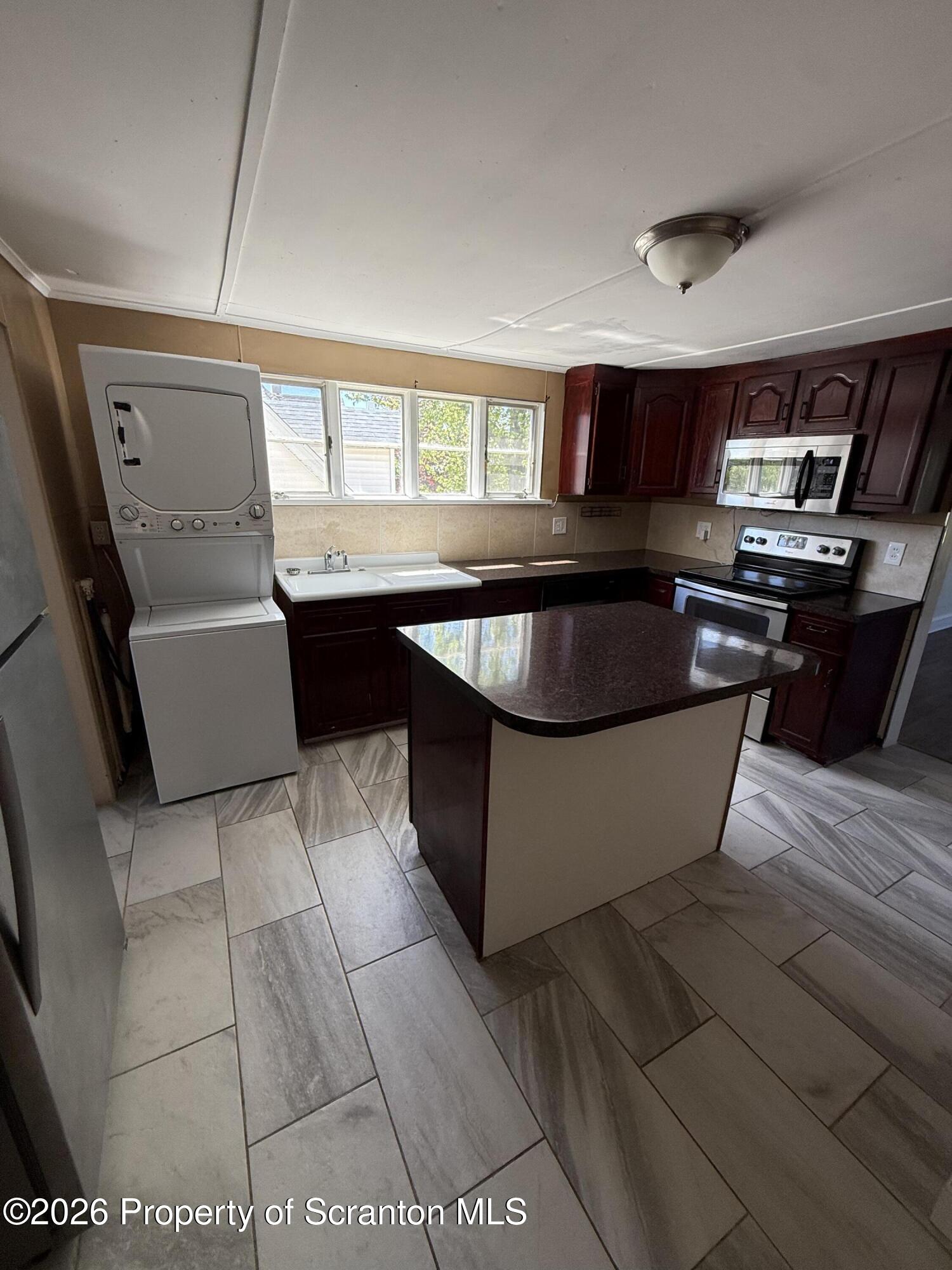 1042 Taylor Avenue, Unit 2 Scranton, PA 18510 - Photo 2 of 14 a kitchen with kitchen island granite countertop a sink a counter top space and appliances