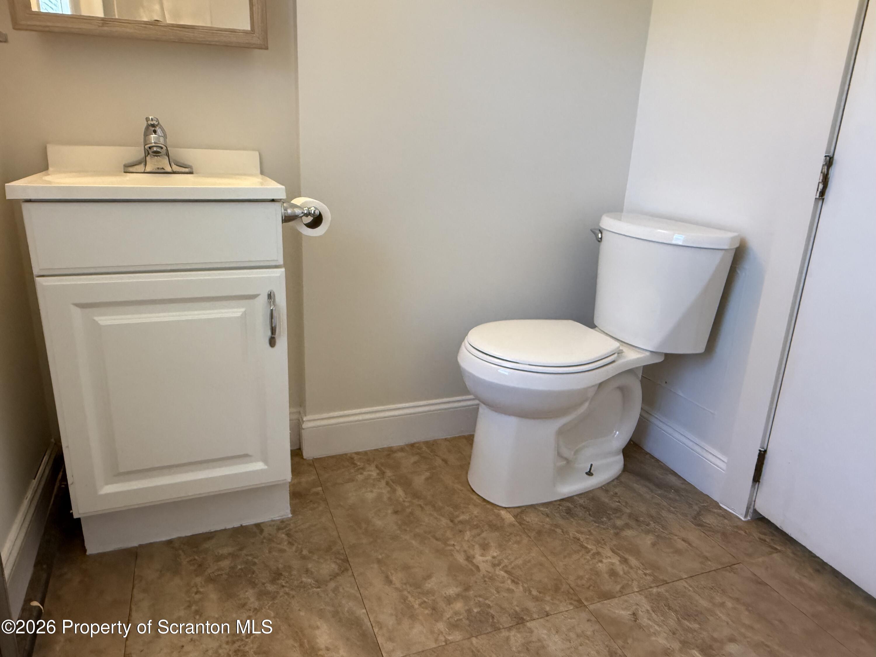 1042 Taylor Avenue, Unit 2 Scranton, PA 18510 - Photo 8 of 14 a bathroom with a sink toilet and a mirror