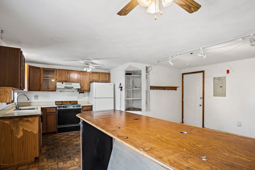 30 Angle Street, Unit 1 Lowell, MA 01851 - Photo 11 of 20 a kitchen with stainless steel appliances granite countertop a sink dishwasher and a refrigerator with wooden floor