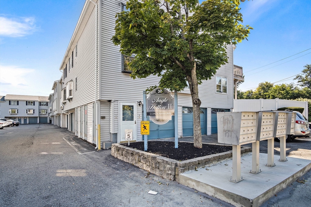 30 Angle Street, Unit 1 Lowell, MA 01851 - Photo 3 of 20 a view of a street with houses