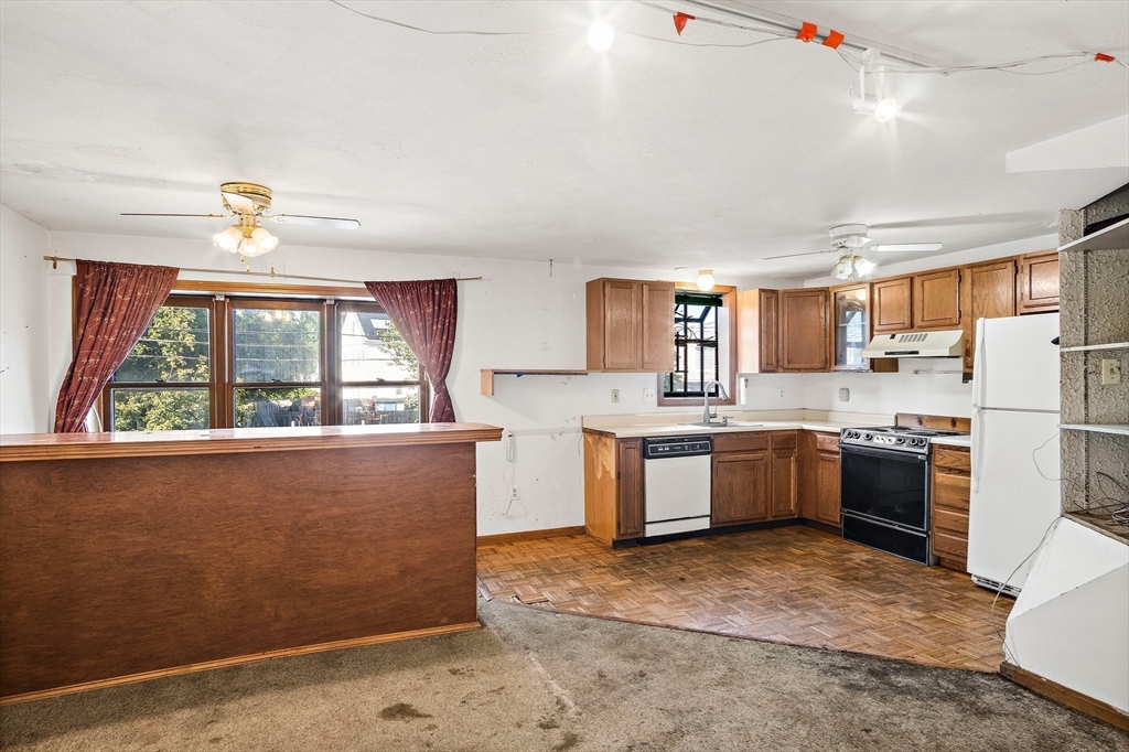 30 Angle Street, Unit 1 Lowell, MA 01851 - Photo 7 of 20 a large kitchen with a large window appliances and cabinets