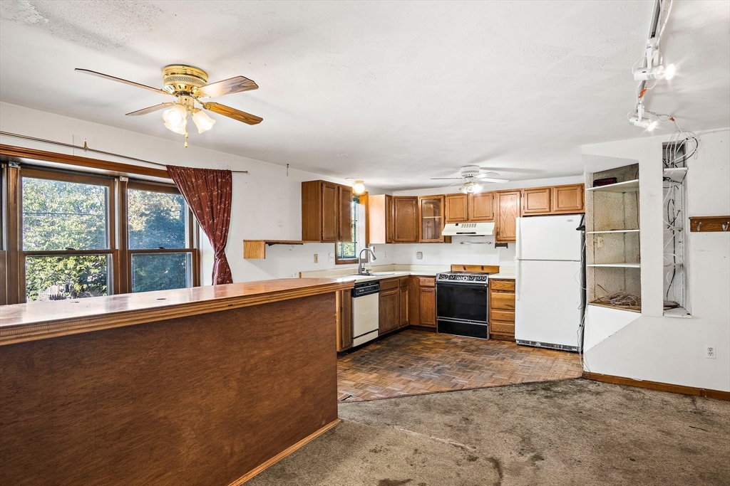 30 Angle Street, Unit 1 Lowell, MA 01851 - Photo 8 of 20 a kitchen with a refrigerator a sink and dishwasher with a large window