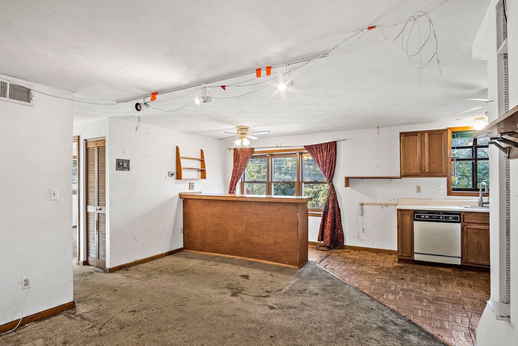 30 Angle Street, Unit 1 Lowell, MA 01851 - Photo 9 of 20 a view of a kitchen with a sink and a refrigerator