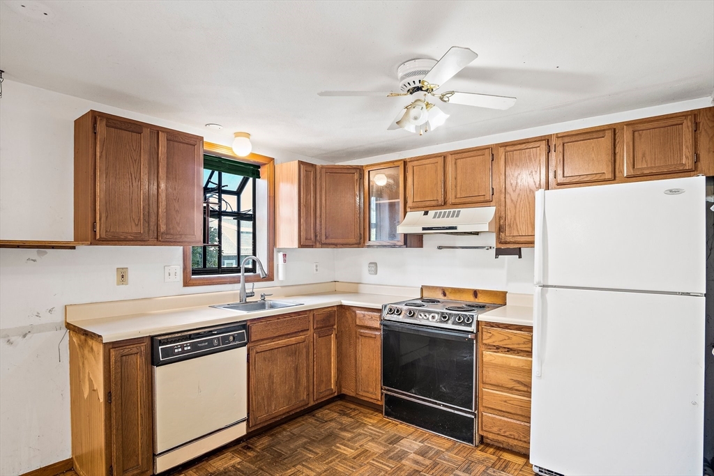 30 Angle Street, Unit 1 Lowell, MA 01851 - Photo 10 of 20 a kitchen with a sink a stove and refrigerator