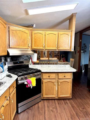 a kitchen with a stove a sink and a microwave