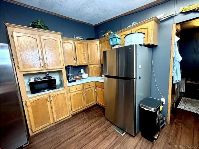 a kitchen with stainless steel appliances a refrigerator sink and cabinets