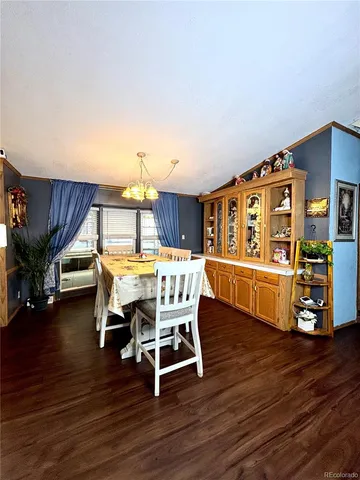 a dining room with furniture and wooden floor