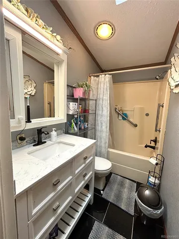 a bathroom with a granite countertop sink toilet a mirror and shower