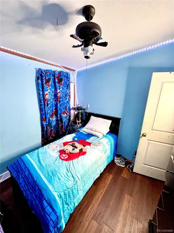 a bedroom with a bed and a painting on the wall