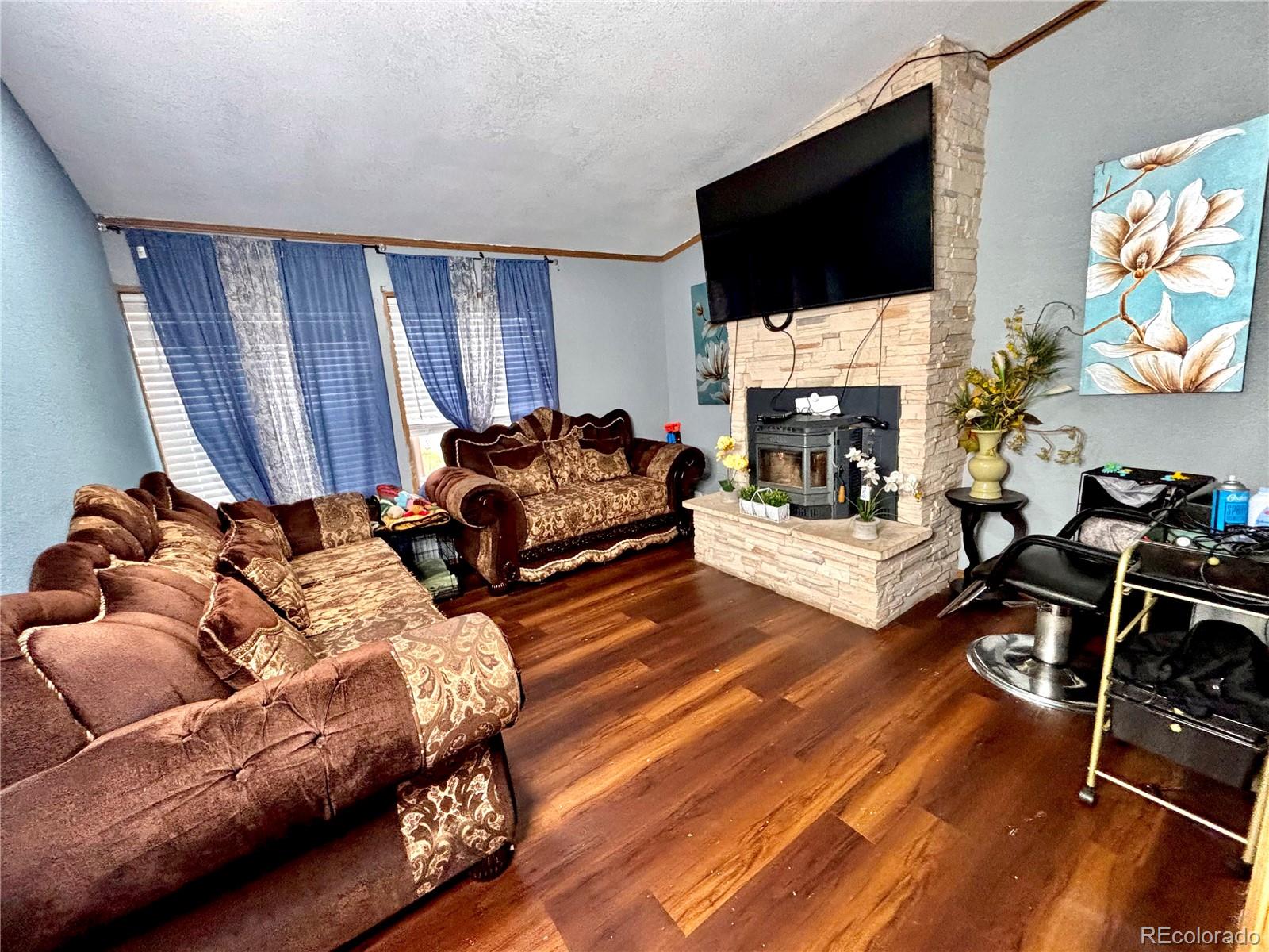 2660 Hawk Street Denver, CO 80260 - Photo 21 of 25 a living room with furniture fireplace and flat screen tv
