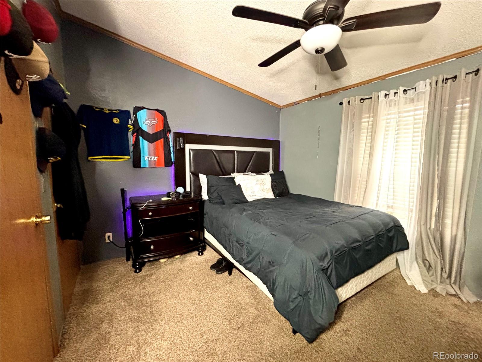 2660 Hawk Street Denver, CO 80260 - Photo 22 of 25 a bed sitting in a bedroom next to a window