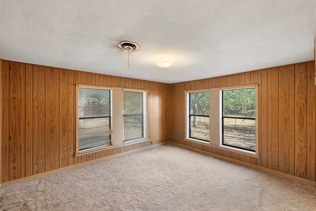 a view of an empty room and closet area