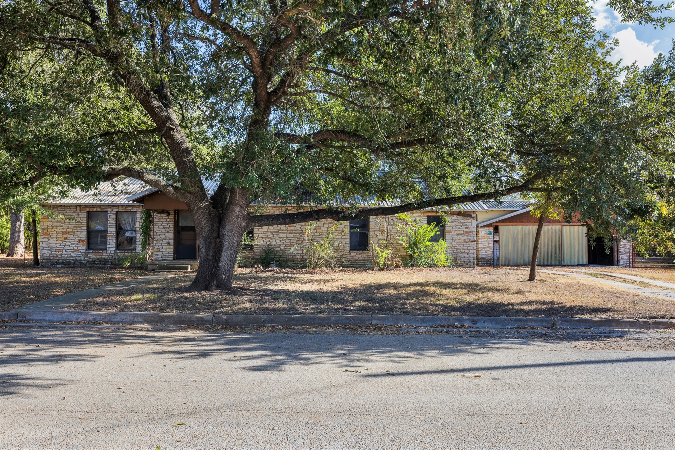 517 First Street Lexington, TX 78947 - Photo 2 of 37 a tree in front of a white house