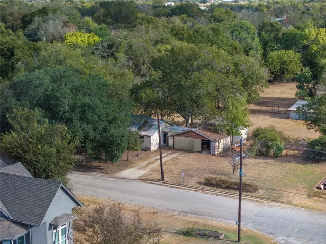 an aerial view of a house with a yard