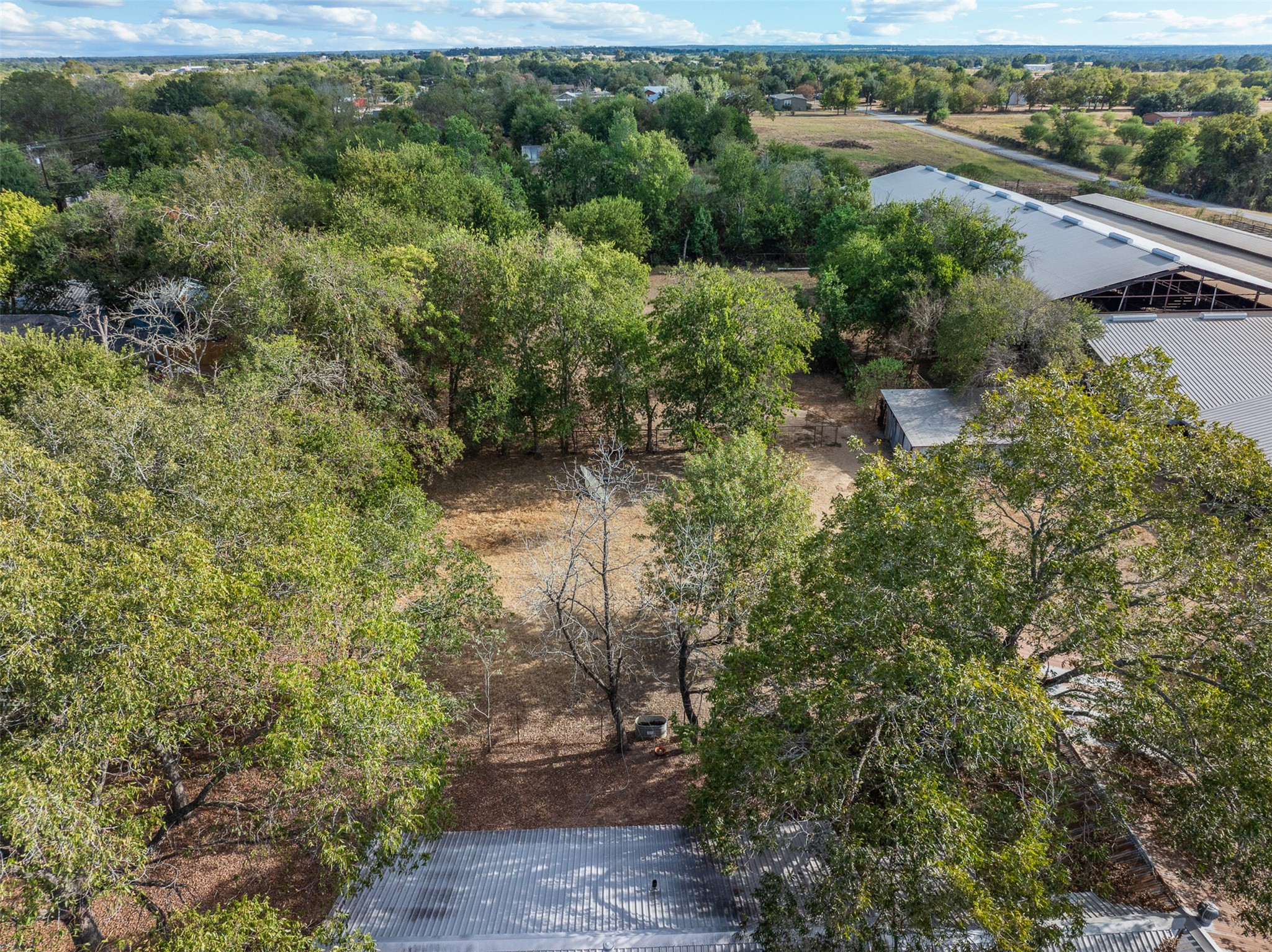 517 First Street Lexington, TX 78947 - Photo 27 of 37 an aerial view of residential house with outdoor space and trees all around