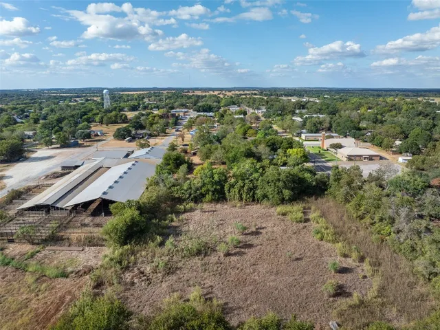 an aerial view of a house with a yard and lake view